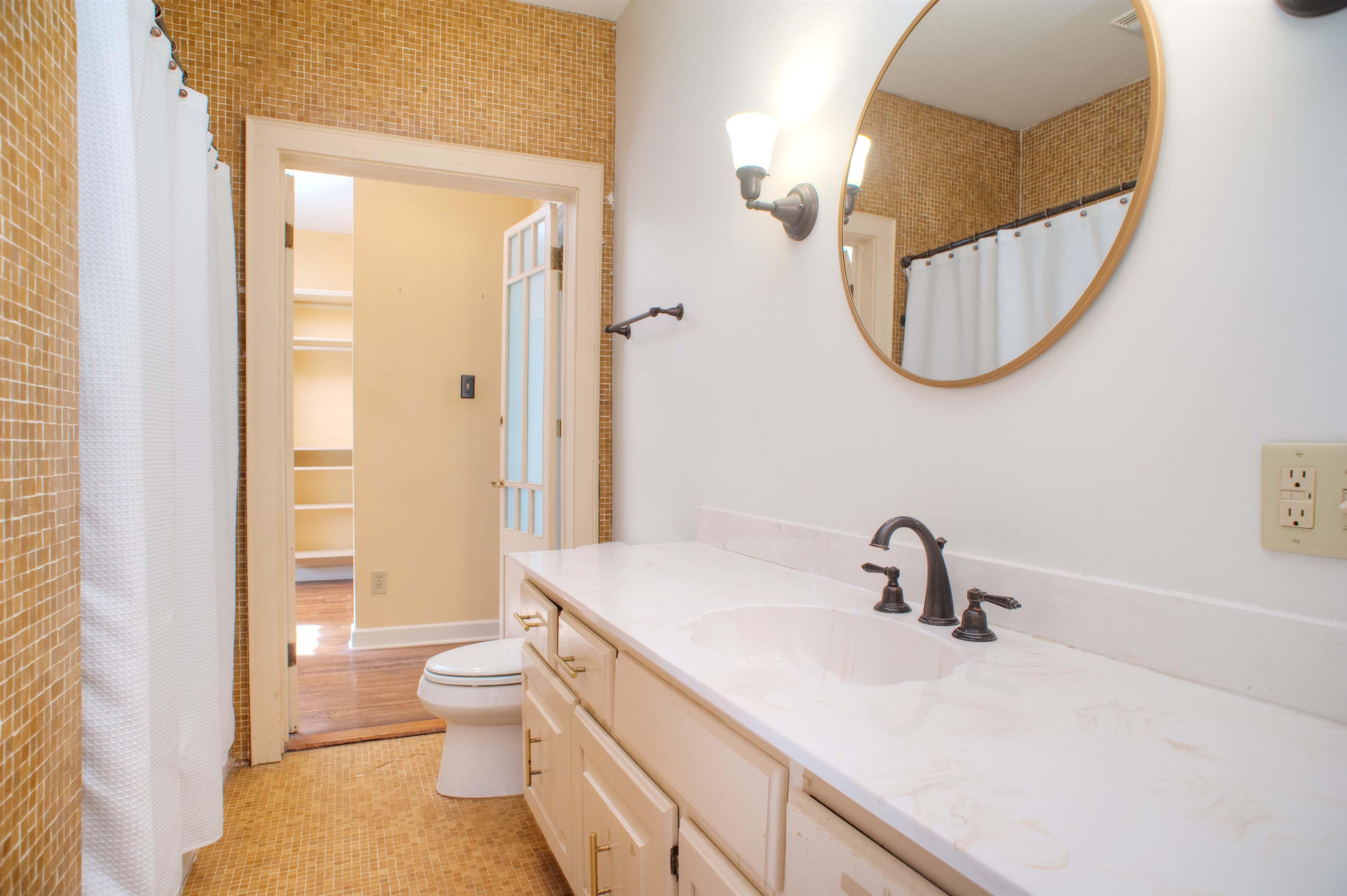 4756 Princeton Road Memphis, TN 38117 - Photo 13 of 22 a bathroom with a sink a toilet and a mirror