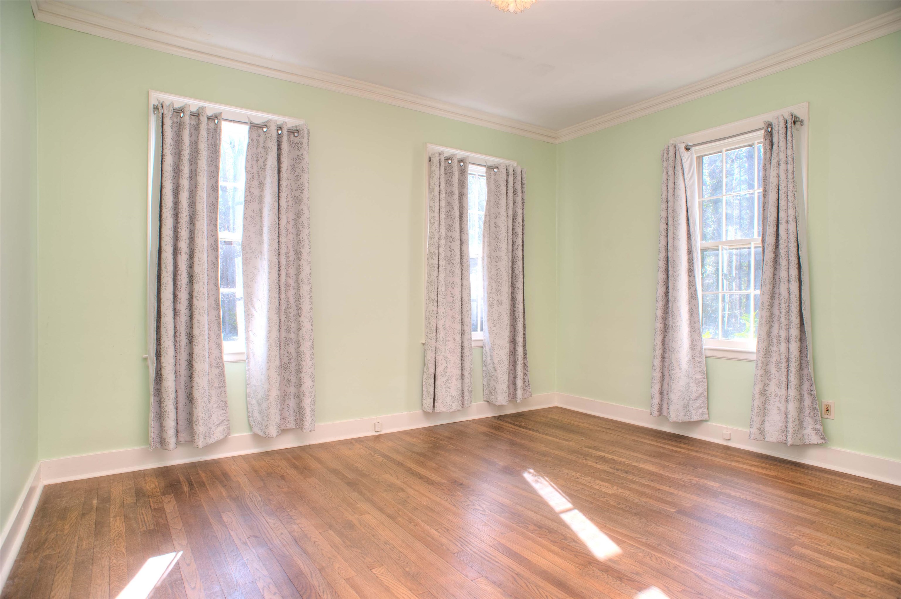 4756 Princeton Road Memphis, TN 38117 - Photo 14 of 22 an empty room with wooden floor and windows