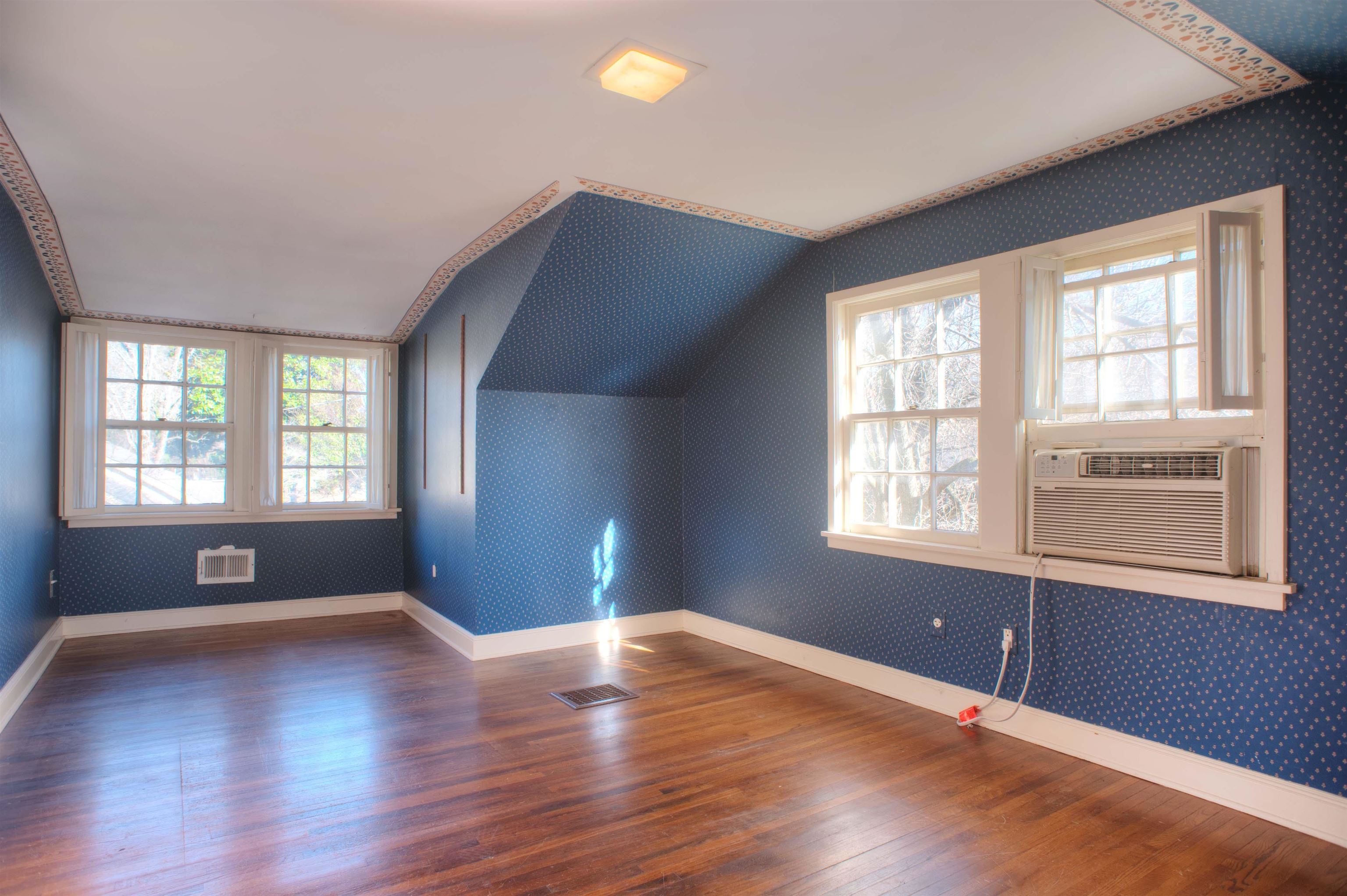 4756 Princeton Road Memphis, TN 38117 - Photo 18 of 22 an empty room with wooden floor and windows