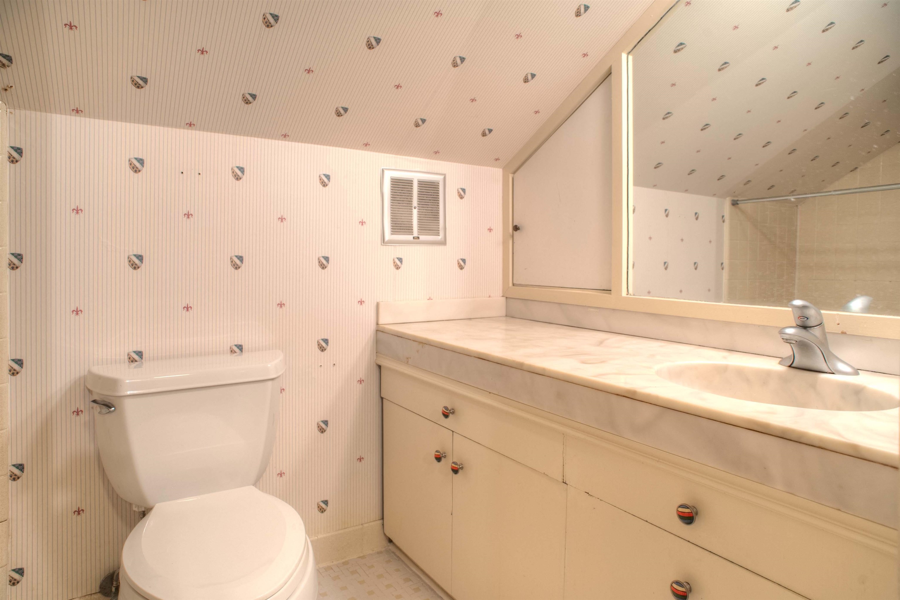 4756 Princeton Road Memphis, TN 38117 - Photo 20 of 22 a bathroom with a toilet sink and mirror