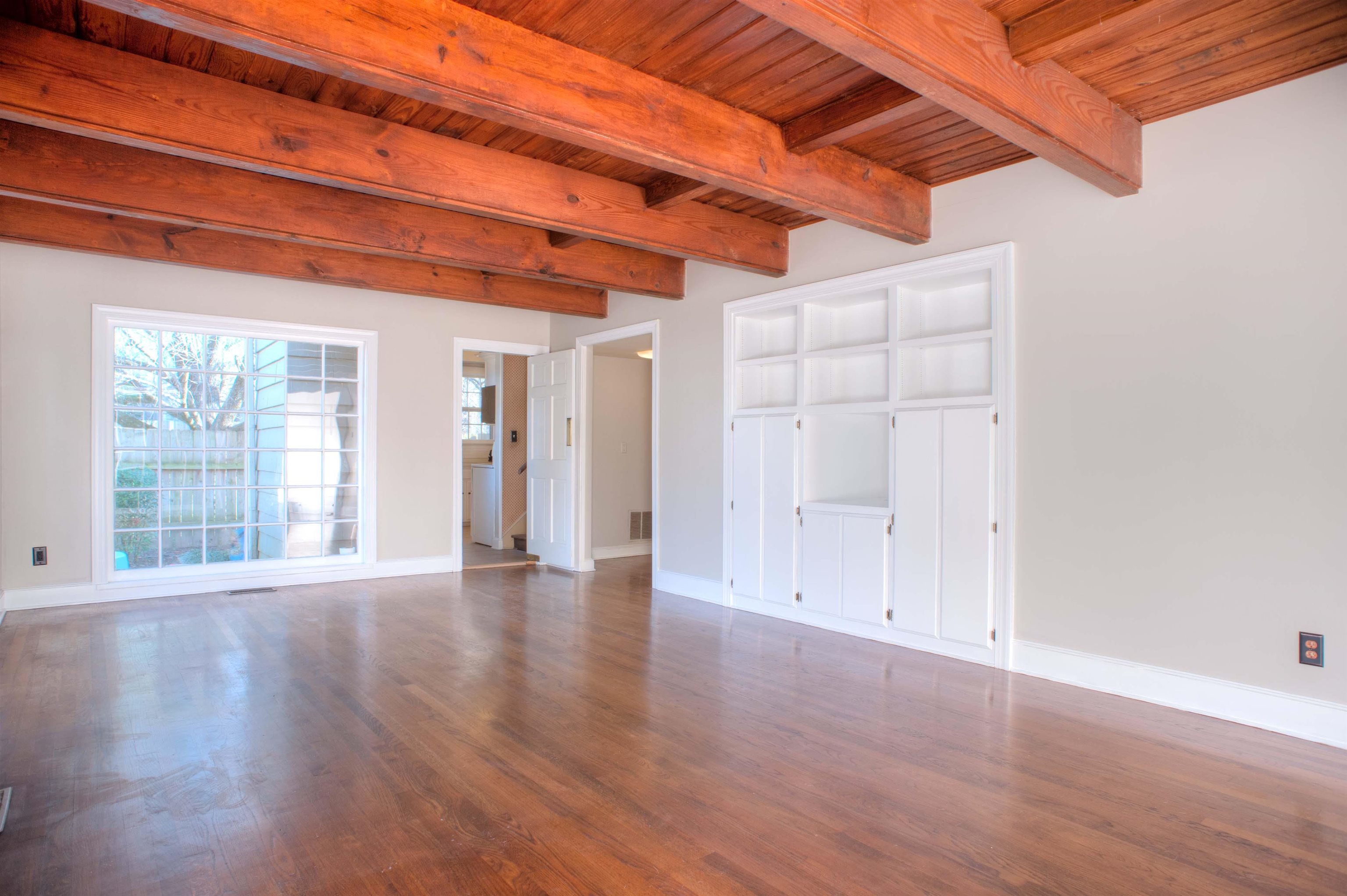 4756 Princeton Road Memphis, TN 38117 - Photo 10 of 22 a view of an empty room with wooden floor and a window