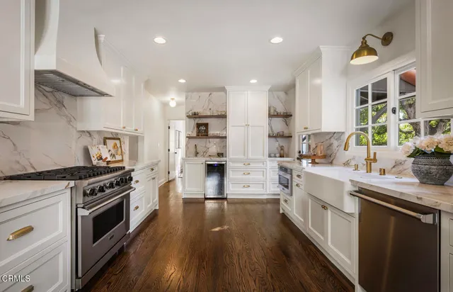 a kitchen with a sink stove and cabinets