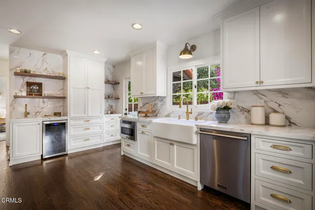 a kitchen with a stove a sink and a microwave
