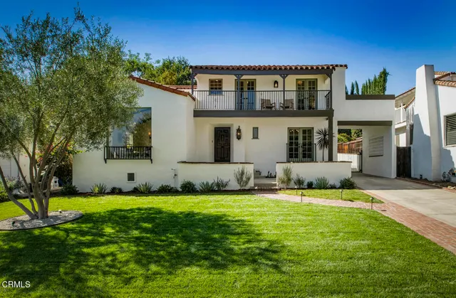 a front view of house with yard and green space