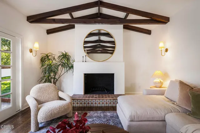 a living room with furniture fireplace and flat screen tv
