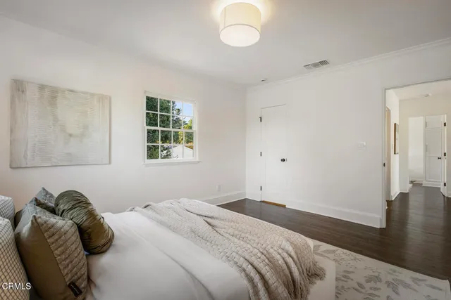 a bathroom with a sink a light fixture and a glass door shower