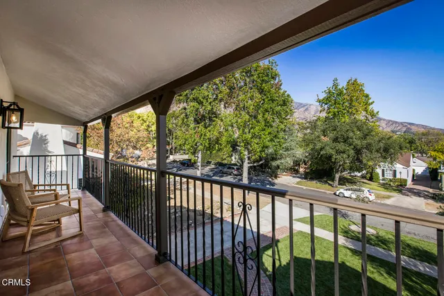 a balcony with table and chairs