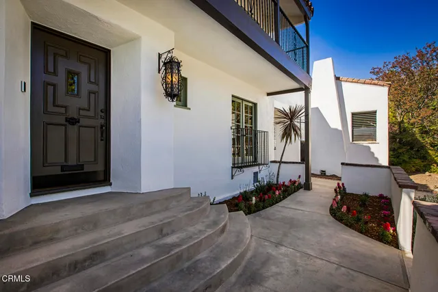 a backyard of a house with wooden walls and windows