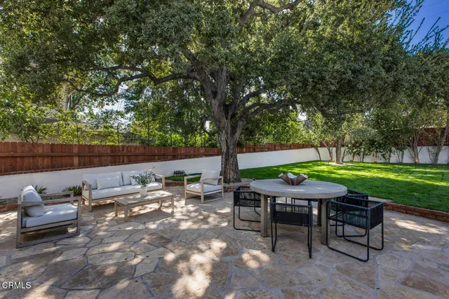 a swimming pool with outdoor seating and yard