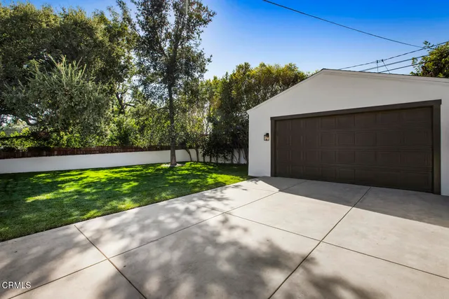 a view of a patio with dining table and chairs with a fire pit and a large tree