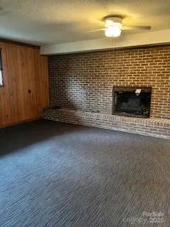 a view of an empty room with a fireplace