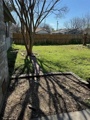 a view of a yard with large trees