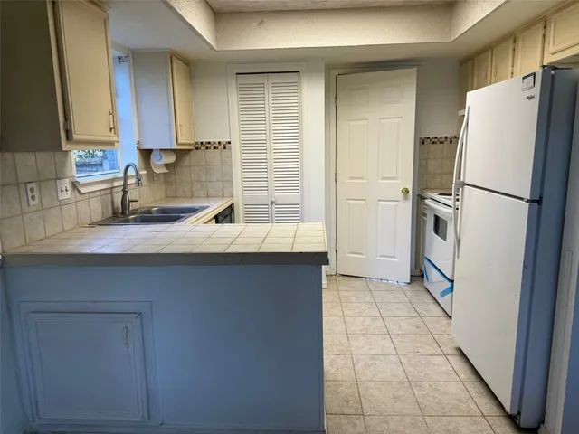 a kitchen with a sink appliances and cabinets