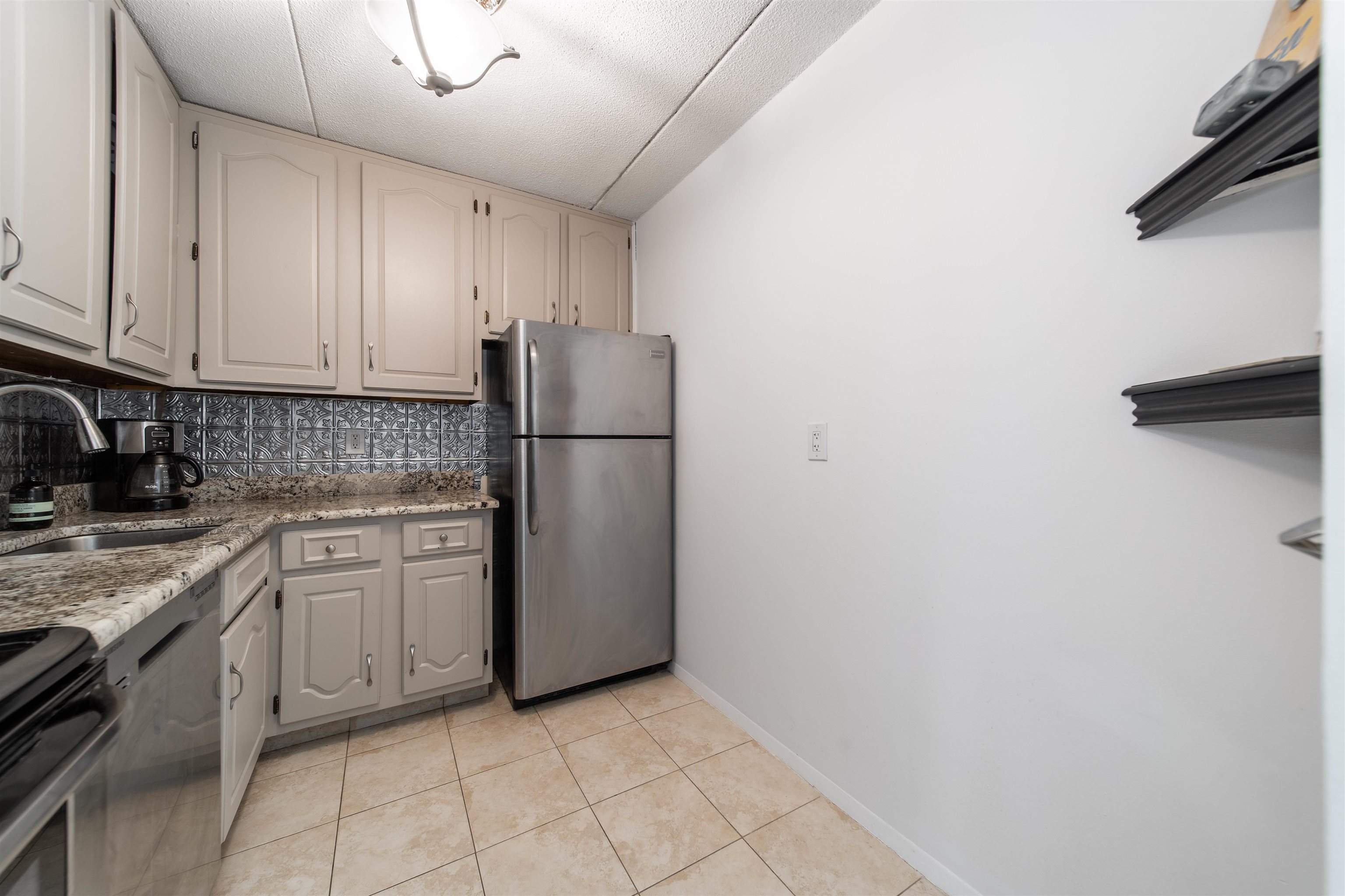 250 Gorge Road, Unit 12K Cliffside Park, NJ 07010 - Photo 11 of 18 a kitchen with a sink a refrigerator and cabinets