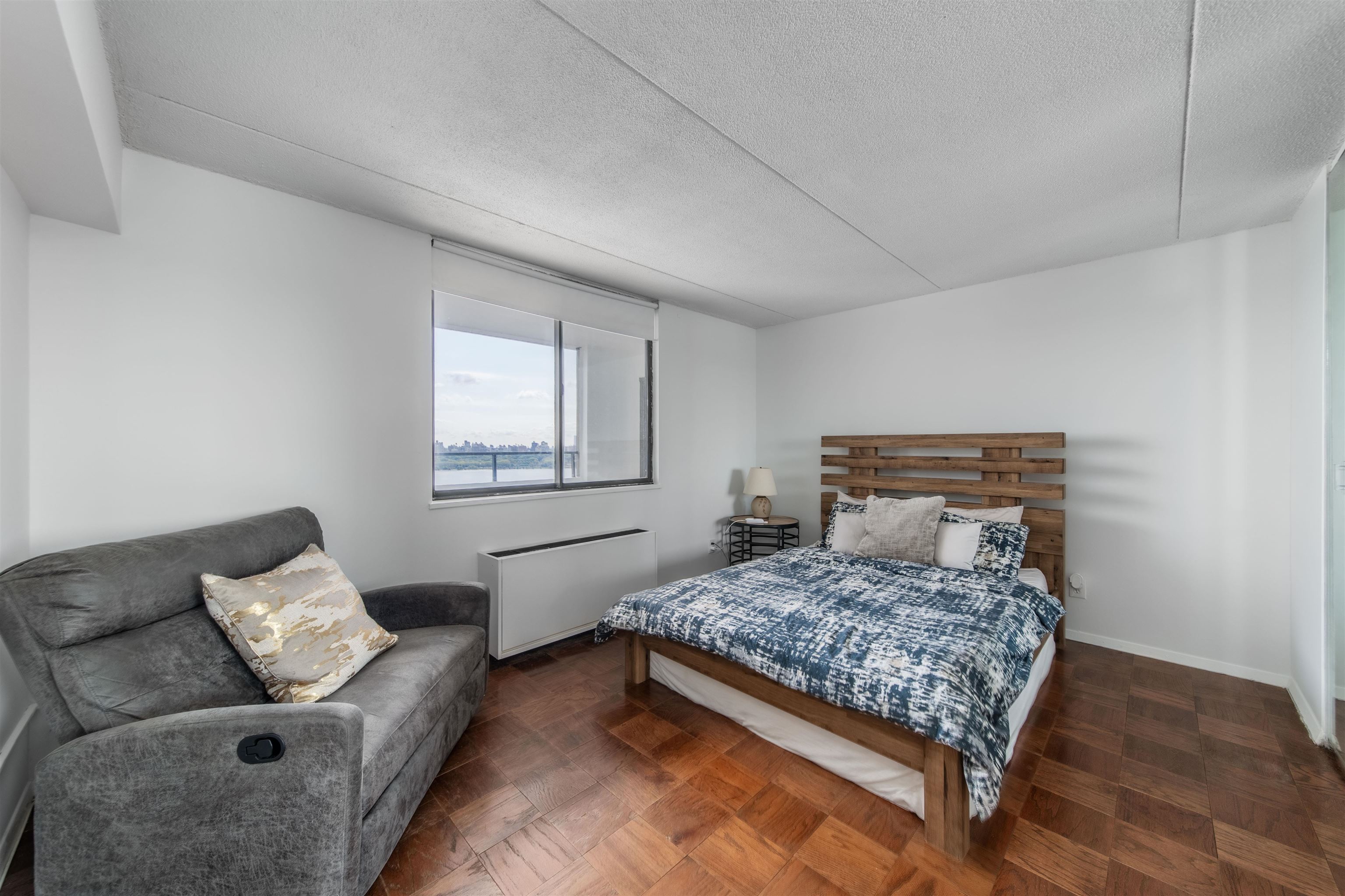 250 Gorge Road, Unit 12K Cliffside Park, NJ 07010 - Photo 12 of 18 a bedroom with a bed and couch