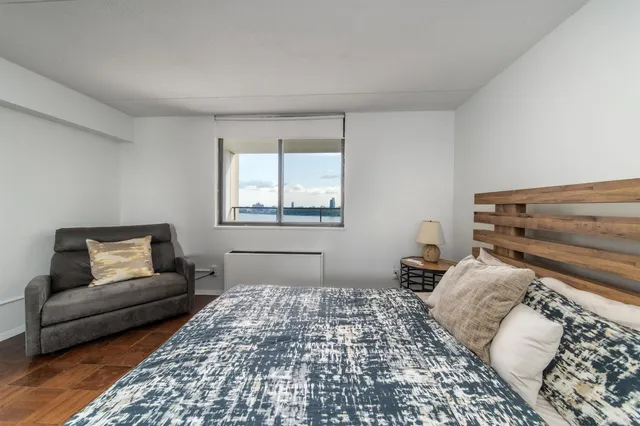 a bedroom with a bed and a couch