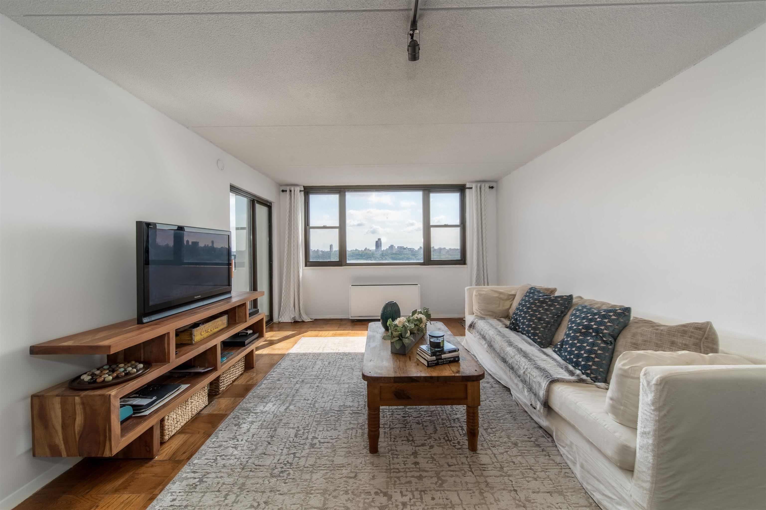 250 Gorge Road, Unit 12K Cliffside Park, NJ 07010 - Photo 2 of 18 a living room with furniture and a flat screen tv