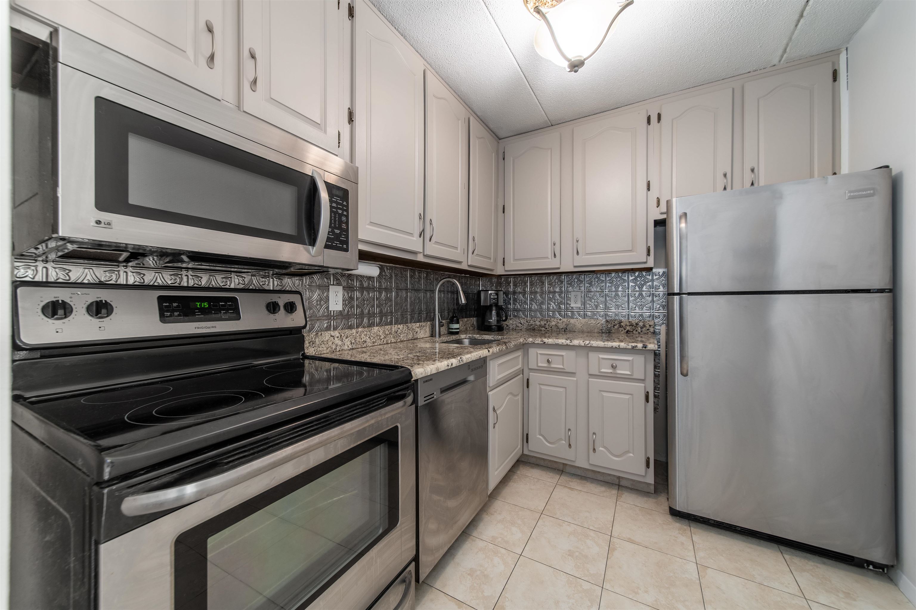 250 Gorge Road, Unit 12K Cliffside Park, NJ 07010 - Photo 10 of 18 a kitchen with appliances a sink and lots of appliances
