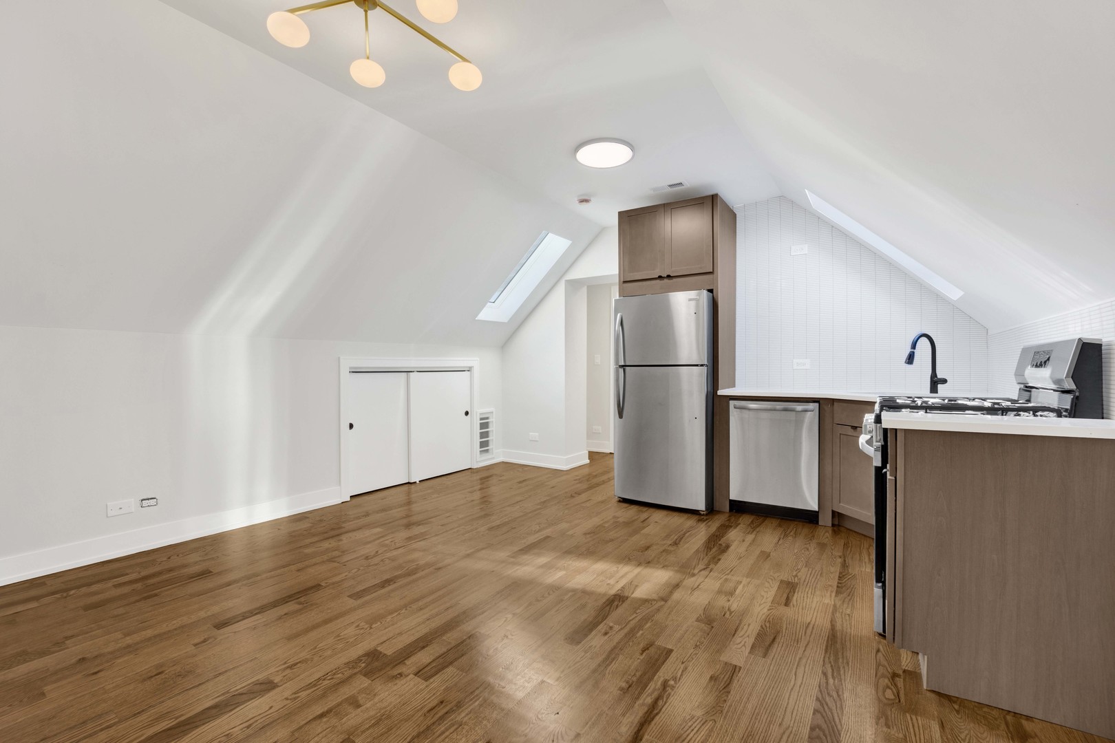 3300 West Pershing Road, Unit GR Chicago, IL 60632 - Photo 2 of 11 a view of a kitchen with wooden floor and electronic appliances