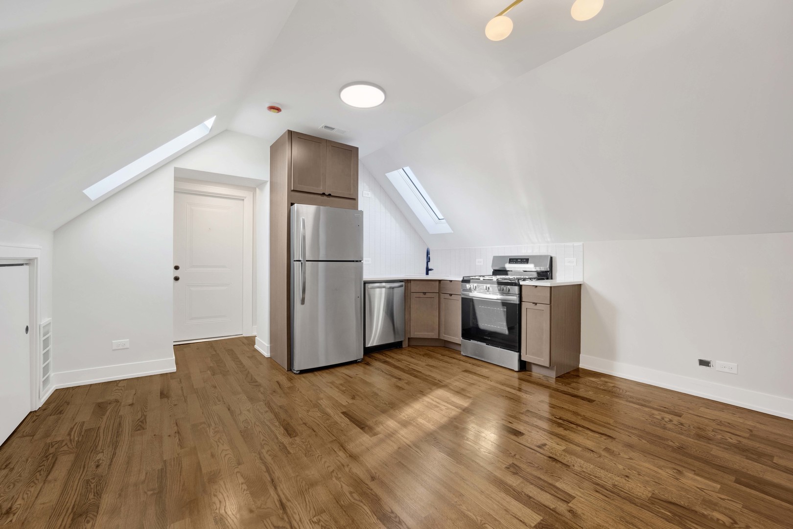 3300 West Pershing Road, Unit GR Chicago, IL 60632 - Photo 3 of 11 a view of a kitchen with refrigerator and wooden floor