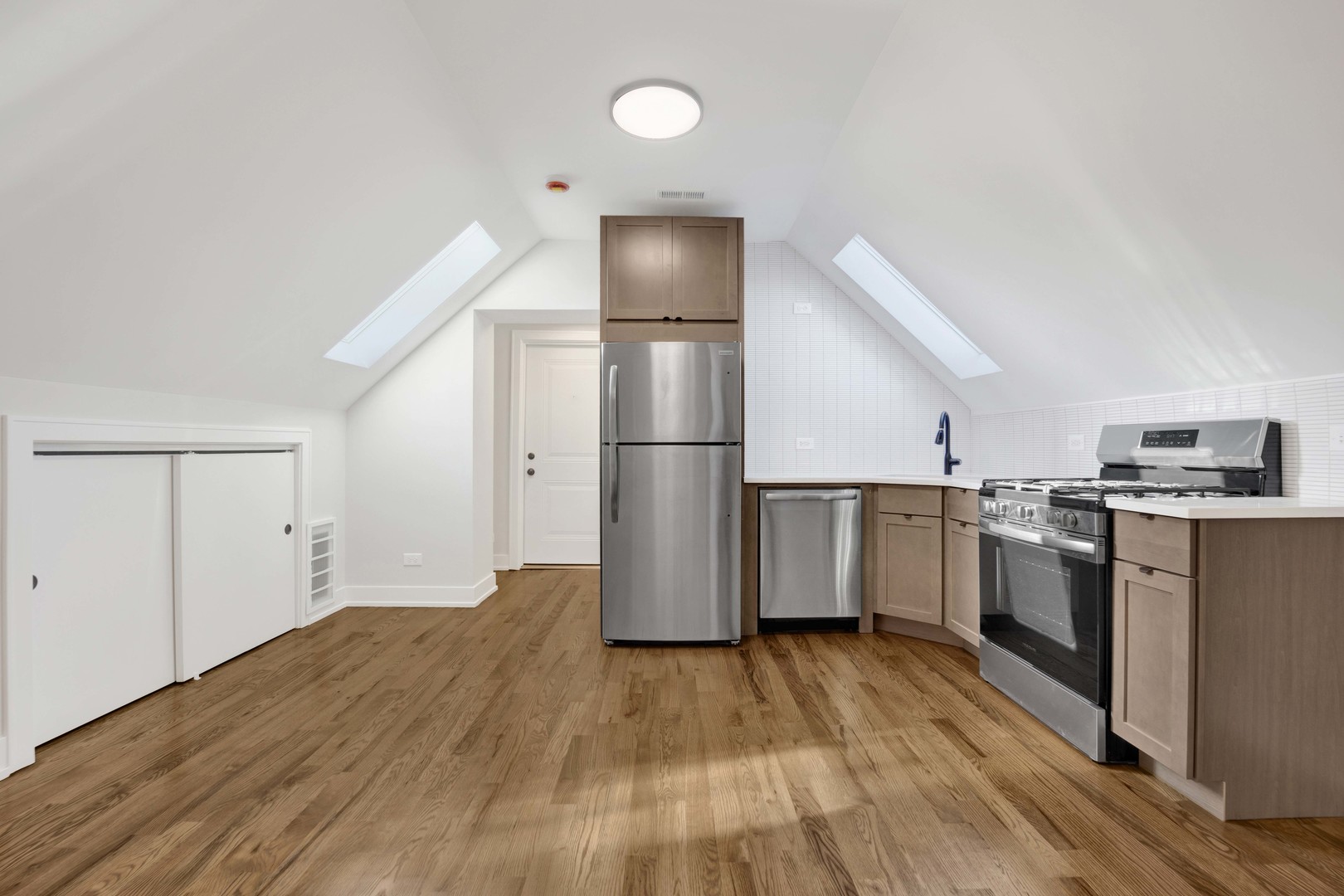 3300 West Pershing Road, Unit GR Chicago, IL 60632 - Photo 4 of 11 a kitchen with a refrigerator and a stove top oven