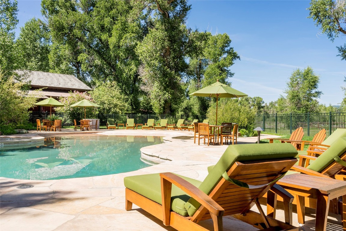 27200 Fire Song Road Steamboat Springs, CO 80487 - Photo 18 of 30 a view of a patio with a table and chairs under an umbrella