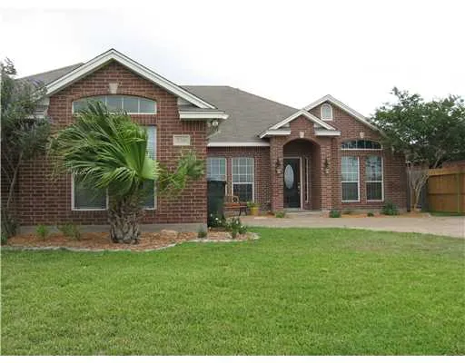 a front view of a house with garden and porch