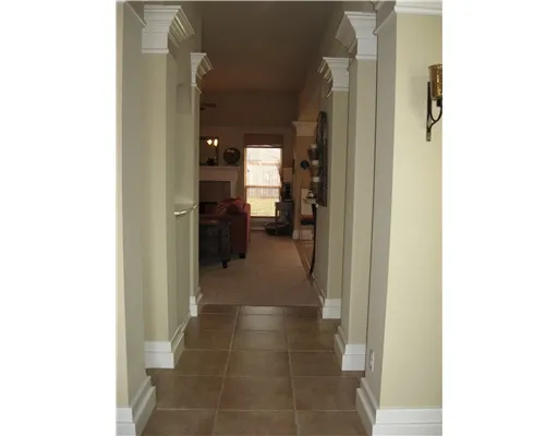 a view of a hallway with wooden shelves