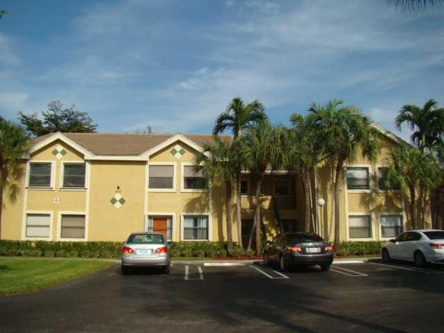 9609 Riverside Drive, Unit 9 Coral Springs, FL 33071 - Photo 1 of 15 a front view of a residential apartment building with a yard