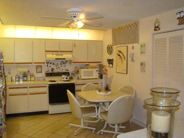9609 Riverside Drive, Unit 9 Coral Springs, FL 33071 - Photo 11 of 15 a kitchen with a table and chairs