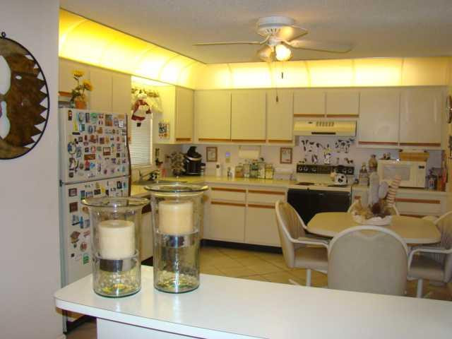 9609 Riverside Drive, Unit 9 Coral Springs, FL 33071 - Photo 2 of 15 a kitchen with a sink and cabinets