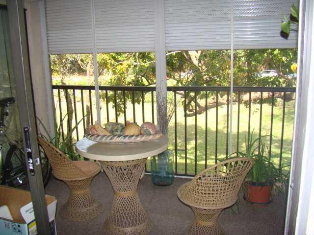 9609 Riverside Drive, Unit 9 Coral Springs, FL 33071 - Photo 7 of 15 a living room with patio furniture and a floor to ceiling window