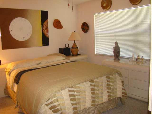 9609 Riverside Drive, Unit 9 Coral Springs, FL 33071 - Photo 9 of 15 a bedroom with a bed and cabinets