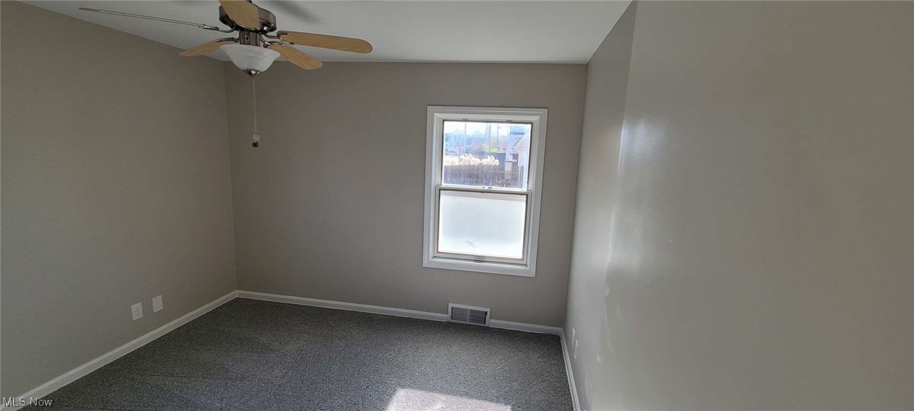 6149 North Canterbury Road Parma, OH 44129 - Photo 6 of 16 Unfurnished room featuring ceiling fan and dark colored carpet