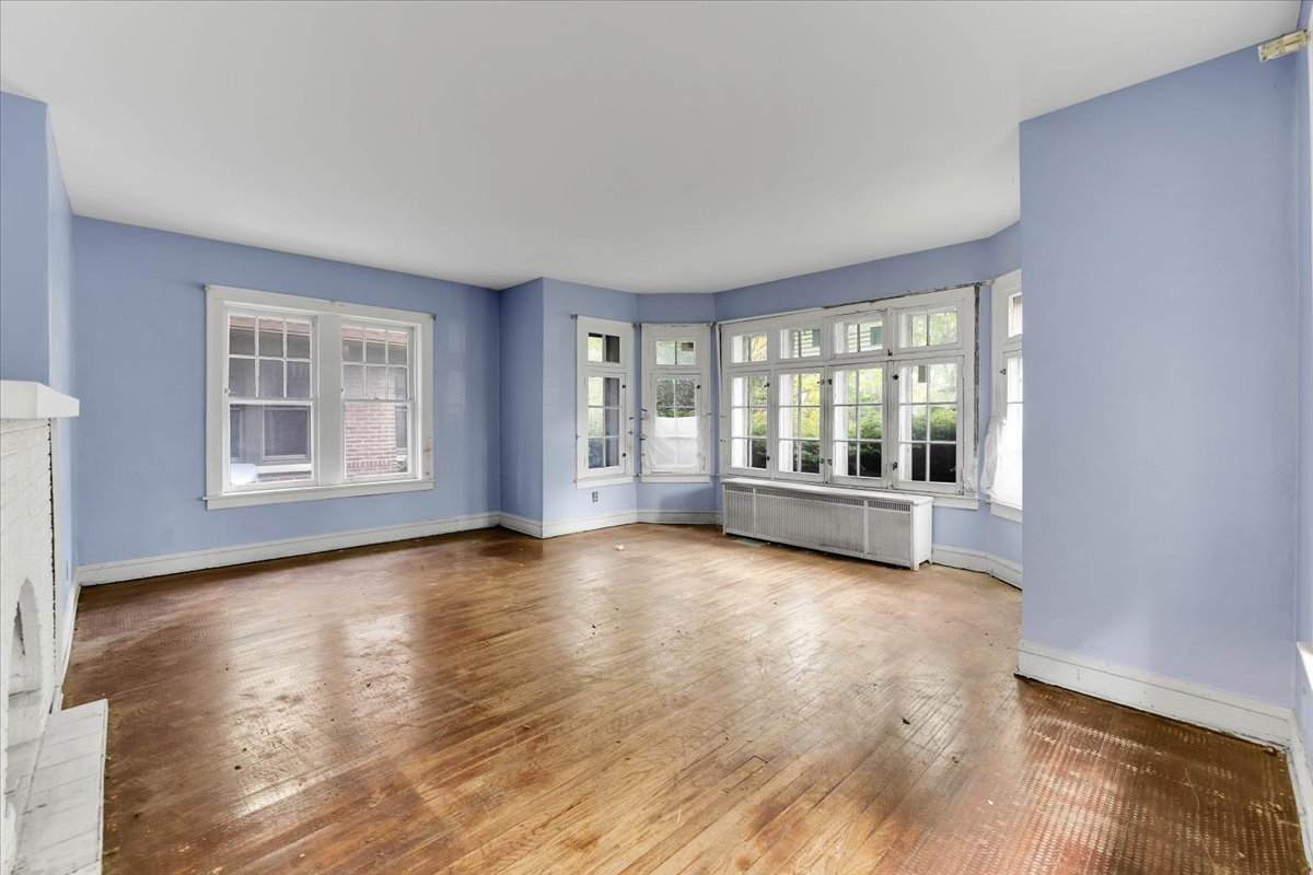 1704 West 94th Street Chicago, IL 60643 - Photo 5 of 29 an empty room with wooden floor and windows