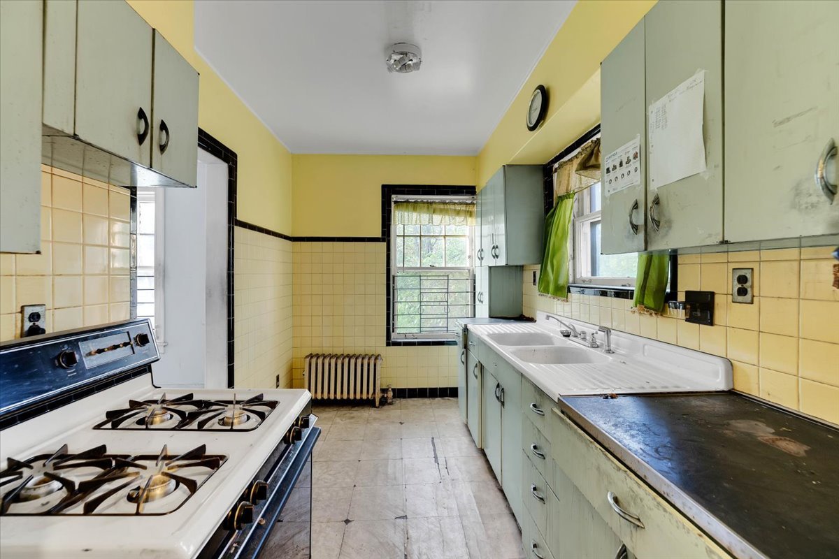 1704 West 94th Street Chicago, IL 60643 - Photo 6 of 29 a kitchen with a stove a sink and a refrigerator