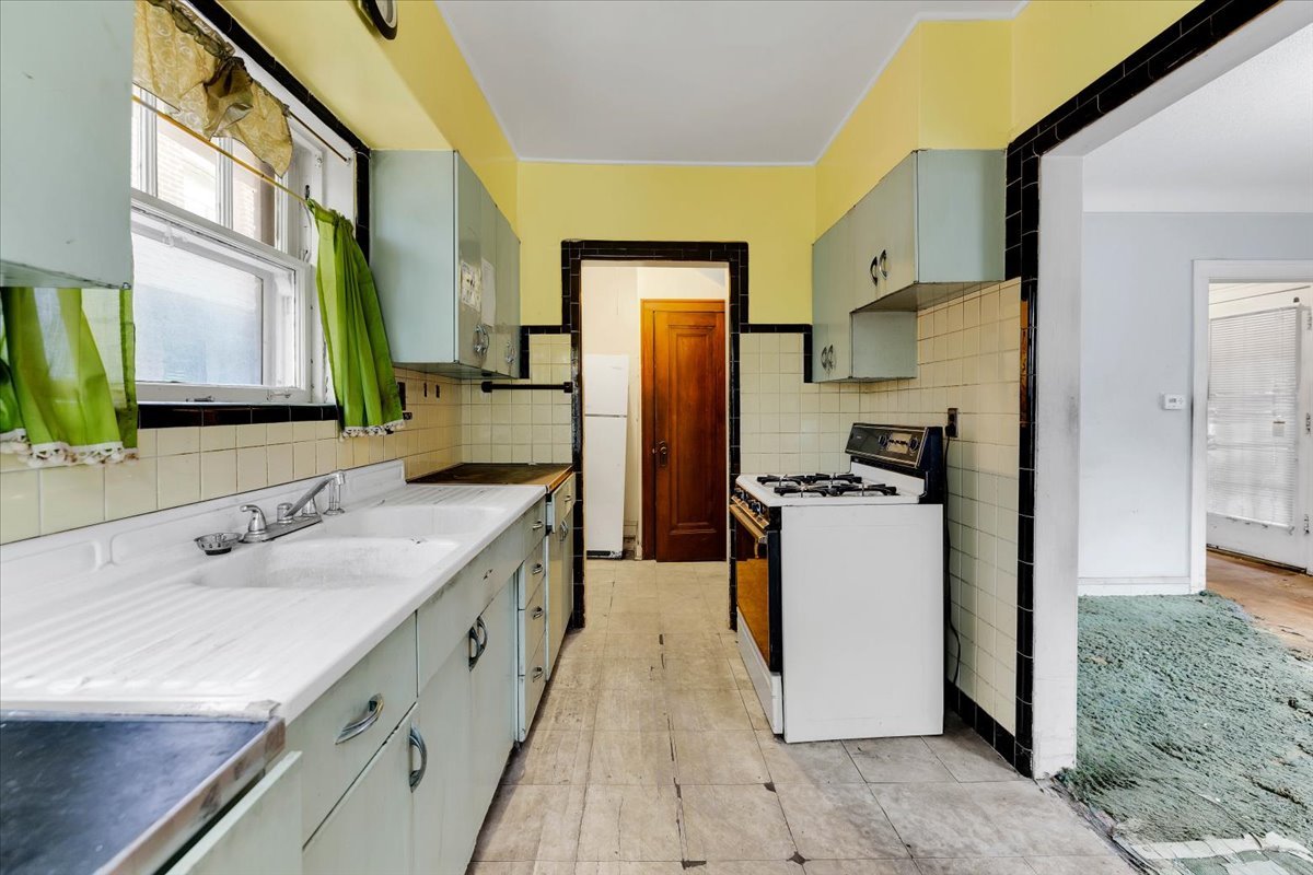 1704 West 94th Street Chicago, IL 60643 - Photo 7 of 29 a kitchen with a sink stove and refrigerator