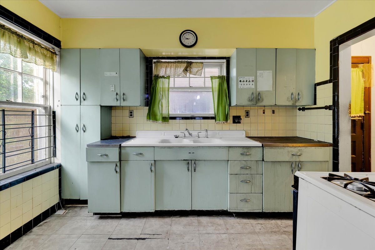 1704 West 94th Street Chicago, IL 60643 - Photo 8 of 29 a kitchen with a sink cabinets appliances and a window