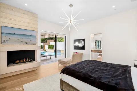 a bedroom with a bed couch and a flat screen tv