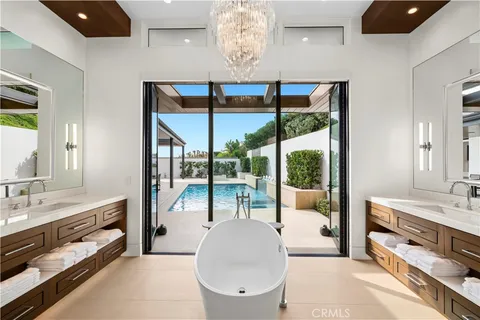 a living room with large windows and furniture