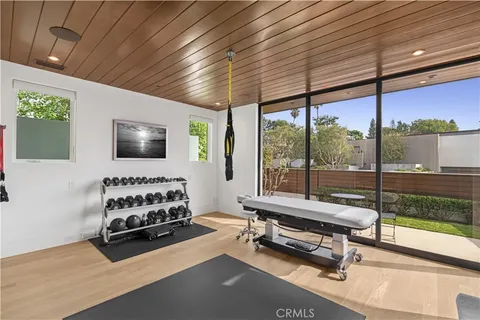a bedroom with furniture and a flat screen tv