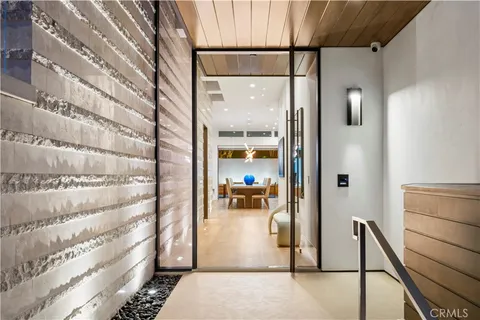 a view of a dining room with furniture large windows and wooden floor