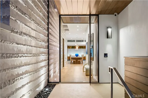 a view of a dining room with furniture large windows and wooden floor