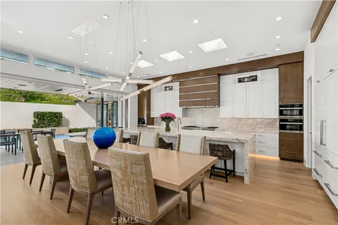 a kitchen with a sink cabinets and wooden floor