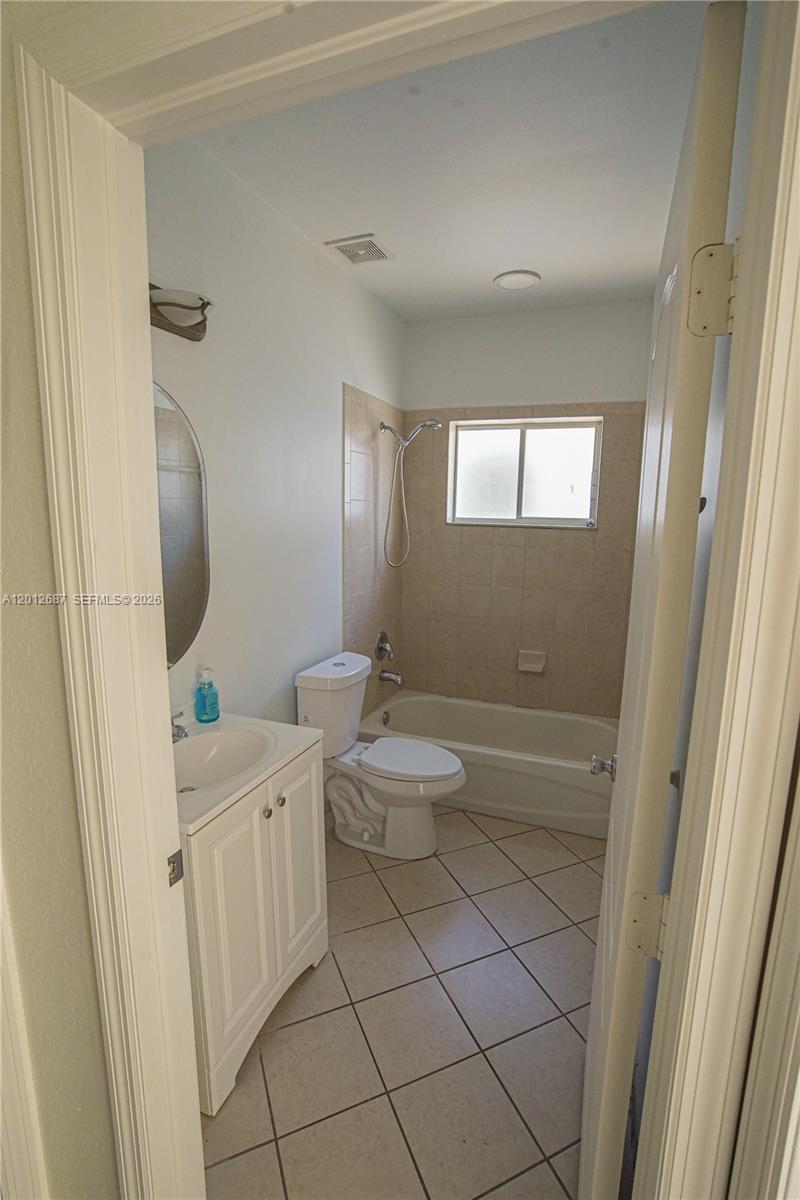 1751 Southwest 154th Path Miami, FL 33185 - Photo 11 of 41 a bathroom with a sink a toilet and shower