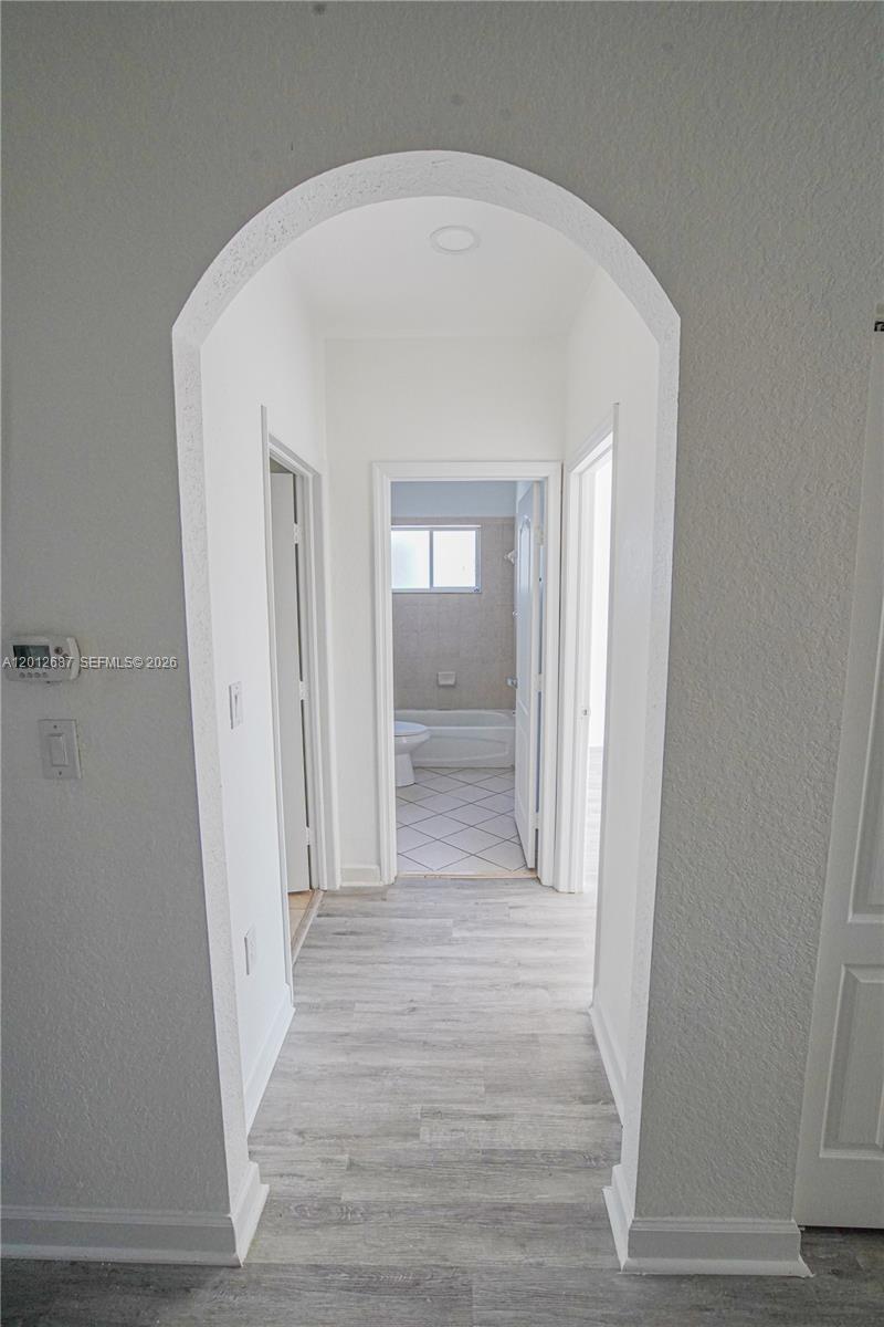 1751 Southwest 154th Path Miami, FL 33185 - Photo 13 of 41 a view of a hallway with wooden floor