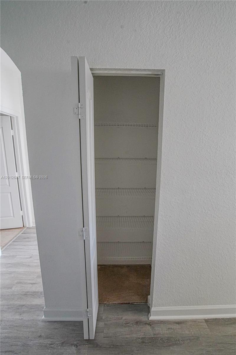1751 Southwest 154th Path Miami, FL 33185 - Photo 14 of 41 a view of walk in closet with empty racks