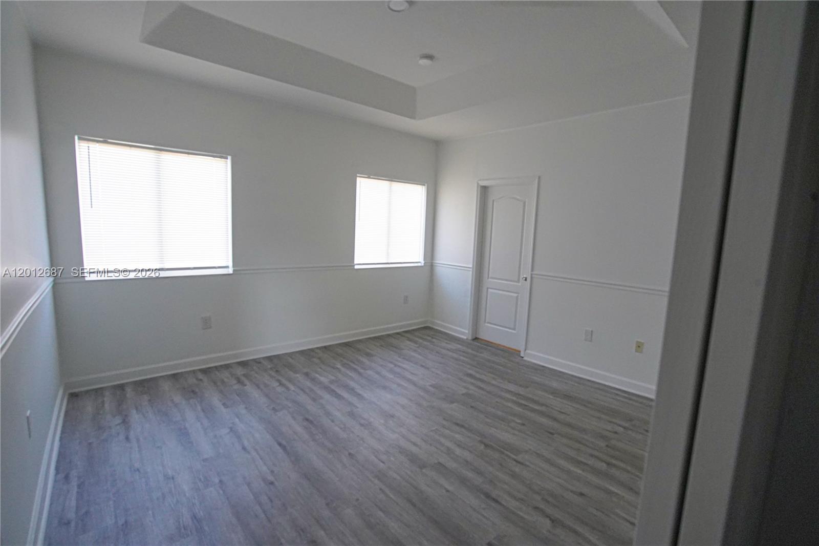 1751 Southwest 154th Path Miami, FL 33185 - Photo 17 of 41 an empty room with wooden floor and windows