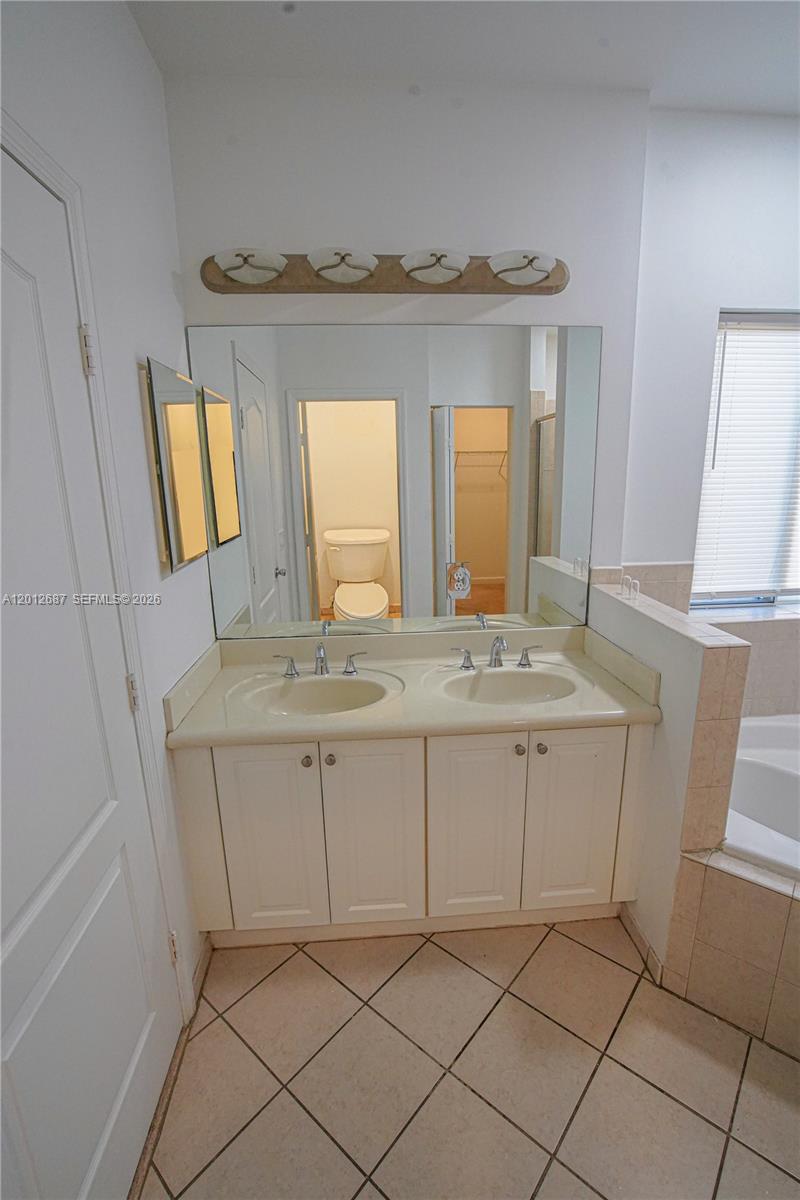 1751 Southwest 154th Path Miami, FL 33185 - Photo 20 of 41 a bathroom with a sink and a mirror