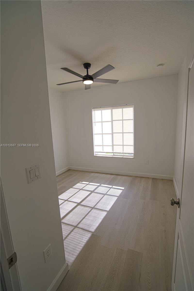 1751 Southwest 154th Path Miami, FL 33185 - Photo 24 of 41 an empty room with windows and fan